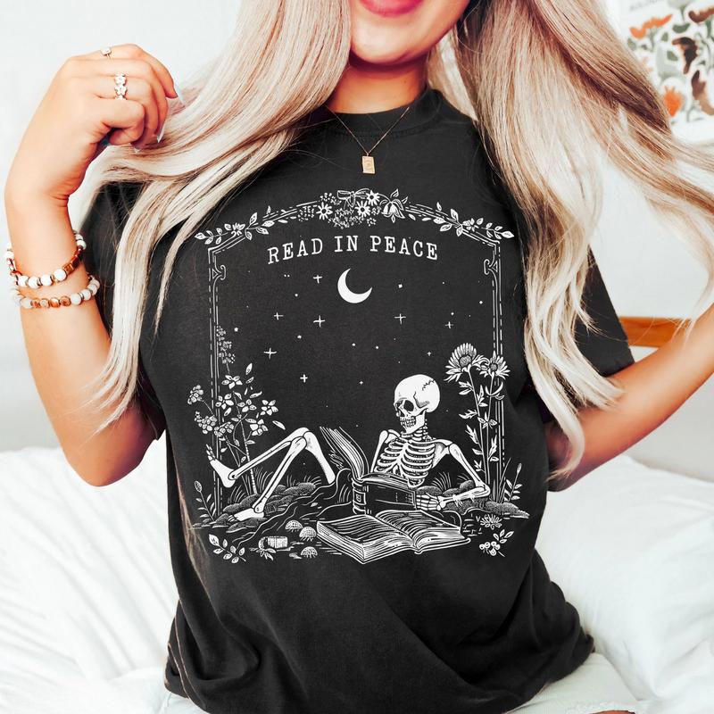Read in Peace Shirt – Skeleton Book Lover Halloween Tee, Perfect for Bookish Ghoul, Unisex T-shirt, Gift for Him, Gift for Her, Crew Neck, Trending T-