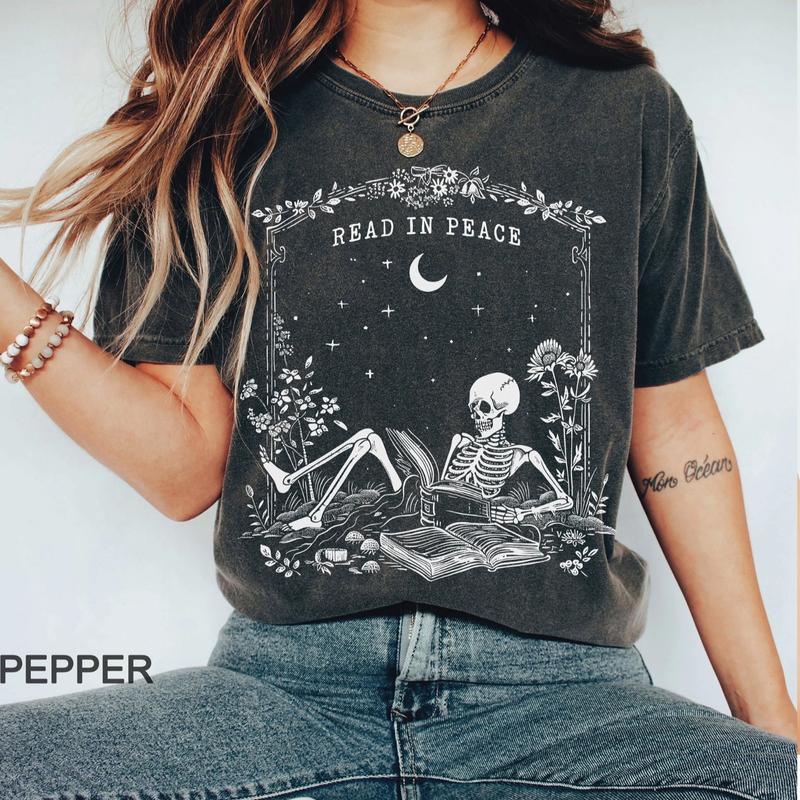 Read in Peace Shirt – Skeleton Book Lover Halloween Tee, Perfect for Bookish Ghoul, Unisex T-shirt, Gift for Him, Gift for Her, Crew Neck, Trending T-